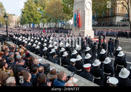 The Cenotaph National Service of Remembrance on Remembrance Sunday. Veterans march past, saluting, following the placing of wreaths by dignitaries. Stock Photo