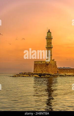 the lighthouse in the harbour of Chania glowing in the sunrise, Chania, Crete, Greece, October 15, 2021 Stock Photo