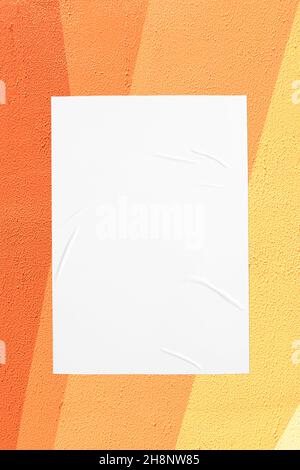 orange yellow urban wall with glued poster Stock Photo