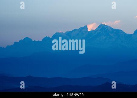 Sunrise on the peaks of Manaslu (left) and Ngadi Chuli/Peak 29 in the Mansiri Himal.  Seen from Bandipur, Nepal. Stock Photo