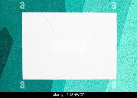teal mint urban wall with glued poster Stock Photo