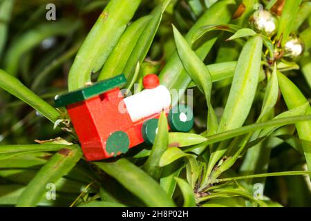 Miniature Christmas Decorations Leaning Against A Wall To Look