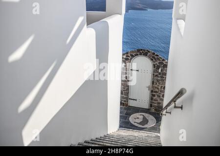 White stairs of the traditional white Greek architecture apartment with a great view on sea, Santorini island, Greece. Summer travel background Stock Photo
