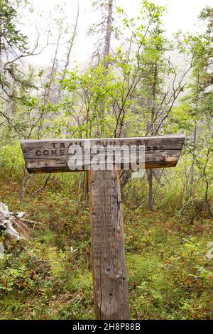 Sign for a hiking trail in the Yukon, Canada. The trail was built by the Conservation Corps in 1978. Stock Photo