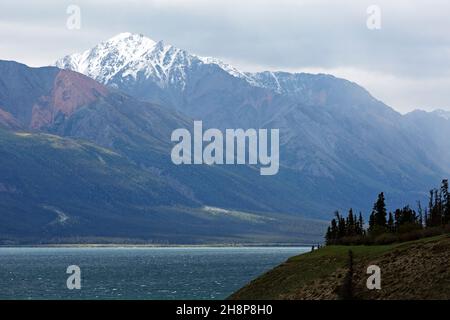 Mountains by the shore of Kluane Lake in the Yukon, Canada. They are part of the St Elias Mountain Range in Kluane National Park and Reserve. Stock Photo