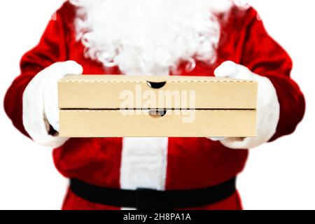 Pizza boxes in the hands of Santa Claus. Isolated on white. Christmas fast food delivery.  New year's eve promotion. Stock Photo