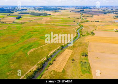 aerial drone shoot. Flying over a beautiful green forest in a rural landscape. Top view of trees in forest background. Drone photography. Forest river Stock Photo