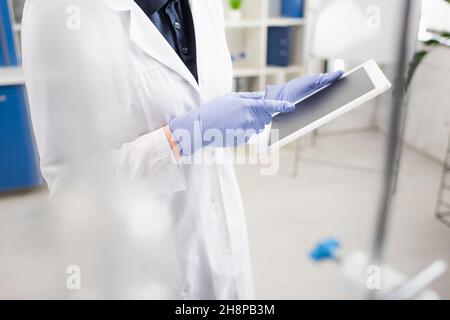 Cropped view of scientist in latex gloves using digital tablet in lab Stock Photo