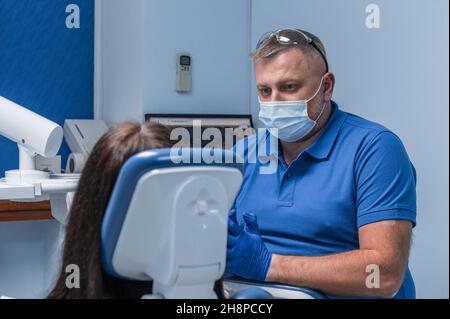 Dentist consults a patient in a dental clinic Stock Photo
