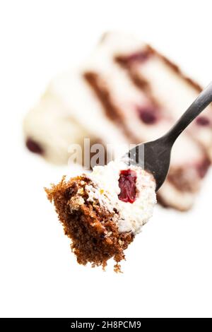 Fork before Black Forest Cake (Schwarzwälder Kirschtorte) on white backgroundSchwarzwälder, Kirschtorte, Cake, fork, piece, black forest cherry cake Stock Photo