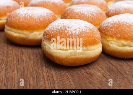 Many donuts on wooden board Donuts, many, Krapfen, Faschingskrapfen, series, white, segment, one Stock Photo