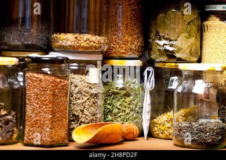 Various dried herbs in glass jars glasses box, different, grains, medicine, gather, cure, medicine cabinet, shovel, side by side, chamomile Stock Photo