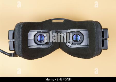 Black fpv or virtual reality glasses with blue lenses isolated on beige. Inside close up view Stock Photo