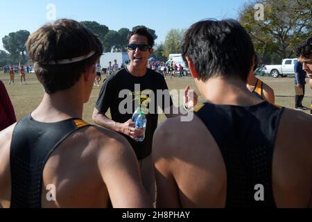 Newbury Park Panthers coach Sean Brosnan talks to runners before the start of the boys Division I race during the CIF State Cross Country Championships at Woodward Park, Saturday, Nov. 27, 2021, in Fresno, Calif. Stock Photo