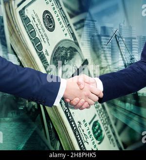 Businessmen shaking hands on background banknotes Stock Photo