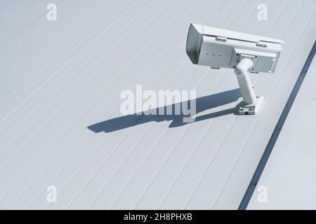 CCTV camera on the wall of the building for monitoring and protection. Total security control system concept. Stock Photo