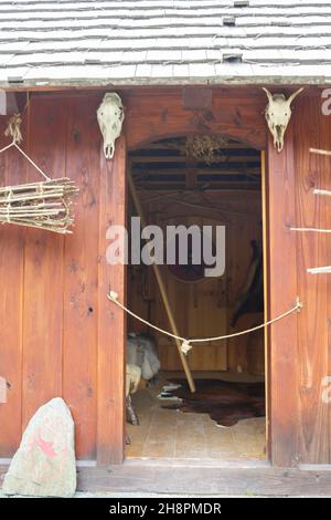 Gudvangen, Norway - Circa September 2021: Entrance of a Viking house with viking decoration Stock Photo