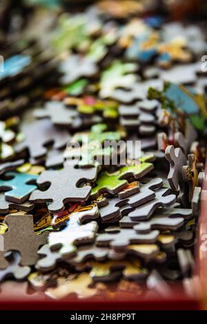 Pieces of a puzzle in a cardboard box Stock Photo