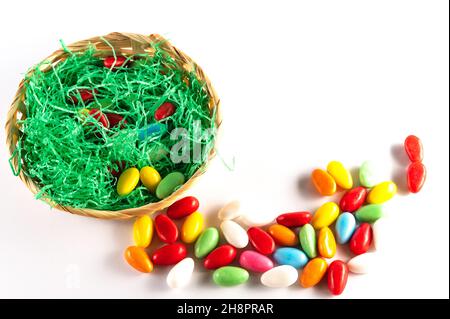 Easter basket with colorful Easter eggs on a light background Stock Photo