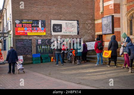 Chesham, Buckinghamshire, UK. 1st December, 2021. People queue outside the Community Fridge in Chesham to purchase a bag of food at a reduced price. Many people are still struggling financially since the Covid-19 Pandemic started. The Community Fridge is a not for profit charity project that aims to redistribute surplus food to the general community that would otherwise become food waste. Credit: Maureen McLean/Alamy Live News Stock Photo