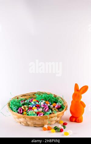 Orange bunny with a filled Easter basket and sweet eggs Stock Photo