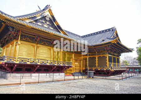 The Ueno Toshogu Shrine in Ueno Park, Tokyo is an ancient Shinto Shrine with lots of bronze lanterns and parts covered with gold foil. Stock Photo