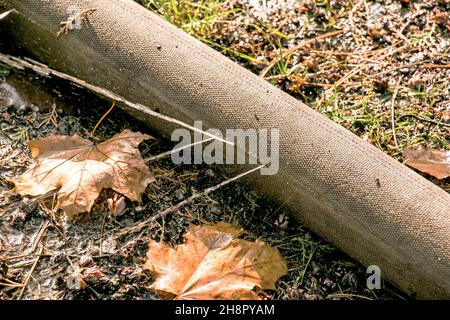 Leakage in the connection of the pipes for pumping water from the pond. A hole in a fire hose from which water flows under pressure. Stock Photo