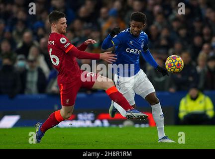Liverpool's Andrew Robertson (left) and Everton's Demarai Gray battle for the ball during the Premier League match between Everton and Liverpool at Goodison Park, Liverpool. Picture date: Wednesday December 1, 2021. Stock Photo