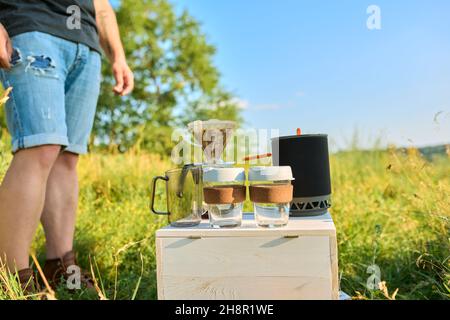 Making camping coffee from a geyser coffee maker on a gas burner,, autumn  outdoor. Male prepares coffee outdoors, travel activity for relaxing,  bushcr Stock Photo - Alamy