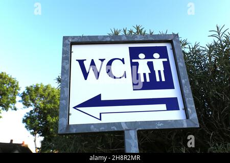 Directional sign for a public restroom for men and women Stock Photo