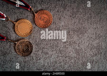 Gold, silver and bronze medals with numbers on interenting background for winners. Medal with tricolor ribbon .Winter olympic games in Beijing 2022, u Stock Photo