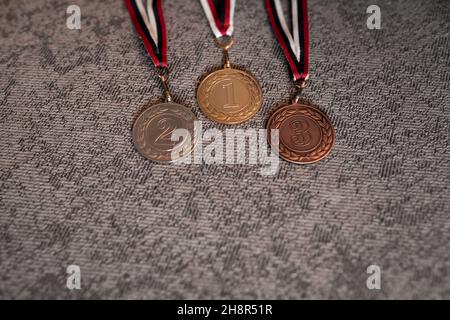 Gold, silver and bronze medals with numbers on interenting background for winners. Medal with tricolor ribbon .Winter olympic games in Beijing 2022, u Stock Photo