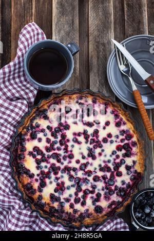 Fresh homemade creamy blueberry and black currant tart (open pie) on rustic background Stock Photo