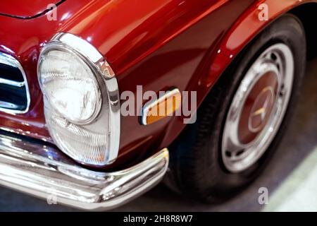 Izmir, Turkey - June 21, 2021: Close up shot of a Mercedes 280 sl red cars headlight which produced between 1968 and 1970. Stock Photo