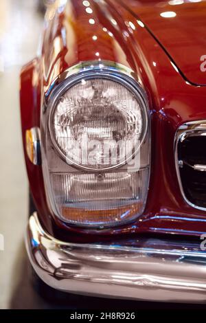 Izmir, Turkey - June 21, 2021: Close up shot of a Mercedes 280 sl red cars headlight which produced between 1968 and 1970. Stock Photo