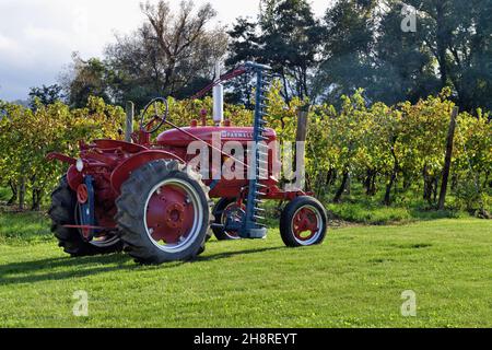 Westfield, New York, USA. Tractor parked by grape vines on a vineyard in western New York state. Stock Photo