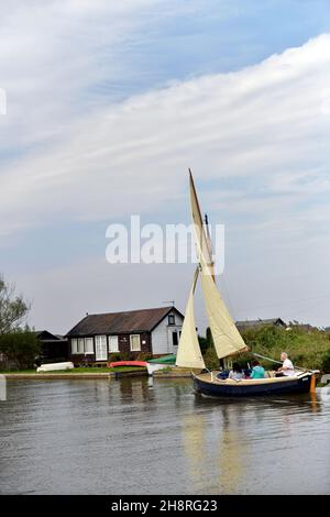 sail boat reaching on river thurne norfolk broads england Stock Photo