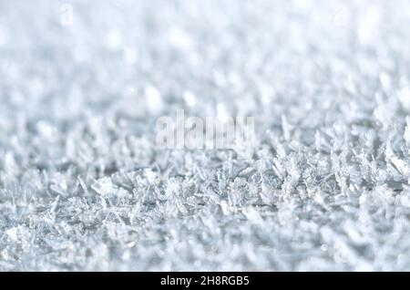 Extreme close-up of ice crystals or hoarfrost in the early morning. Can be used as a frosty winter background with copy space. Very short depth of fie Stock Photo