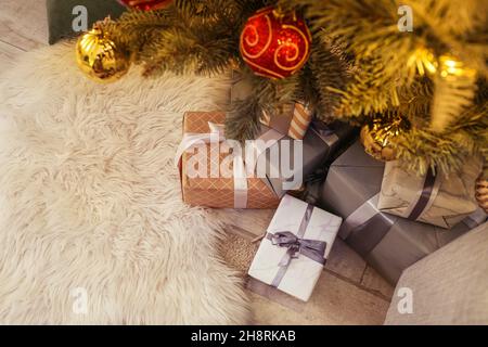 Many gifts under Christmas tree on floor Stock Photo