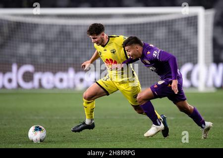 Wellington Phoenix defender Liberato Cacace (13) and Perth Glory forward Dane Ingham (23) contest the ball Stock Photo