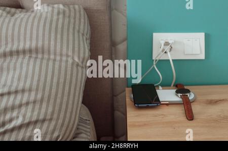 Bedside charging for phone and smart watch Stock Photo