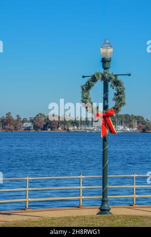 Christmas Wreath hanging from a light post in Union Point Park, New Bern, Craven County, North Carolina Stock Photo