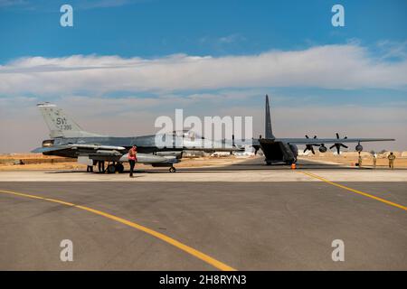 U.S. Airmen from the 26th Expeditionary Rescue Squadron set up a Forward Area Refueling Point (FARP) for two F-16C Fighting Falcons Nov. 26, 2021, at an undisclosed location somewhere in Southwest Asia. FARP training prepares Airmen to effectively refuel aircraft in austere locations when air-to-air refueling is not possible or when fueling stations are not accessible. (U.S. Air Force photo by Senior Airman Karla Parra) Stock Photo