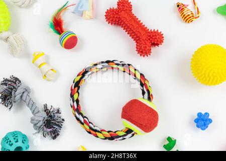 Set of colorful toys, bones, ropes made of cotton, plastic, rubber for dogs and cats. Pets care and accessories on white background Stock Photo