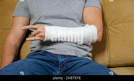 Man shows rock sign with fingers of broken spoke bone Stock Photo