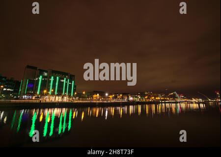 Beautiful wide angle evening view of River Liffey with buildings and landmarks and light reflection in water, Dublin, Ireland Stock Photo