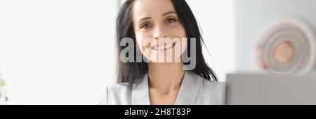 Smiling businesswoman holding diary with silver pen in hand Stock Photo