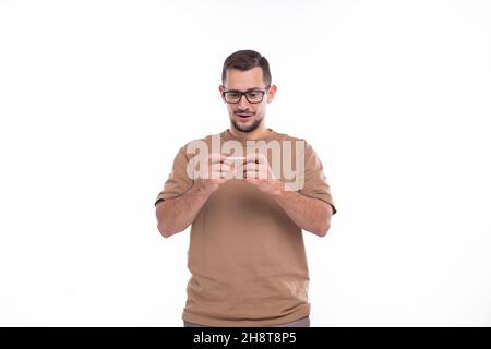 Man Playing Phone Games. Man Using Phone Isolated. Man Watching Video. Stock Photo