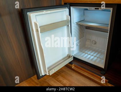 A small empty refrigerator with its door open. Stock Photo
