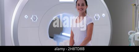 Young female patient sitting in magnetic resonance imaging machine Stock Photo